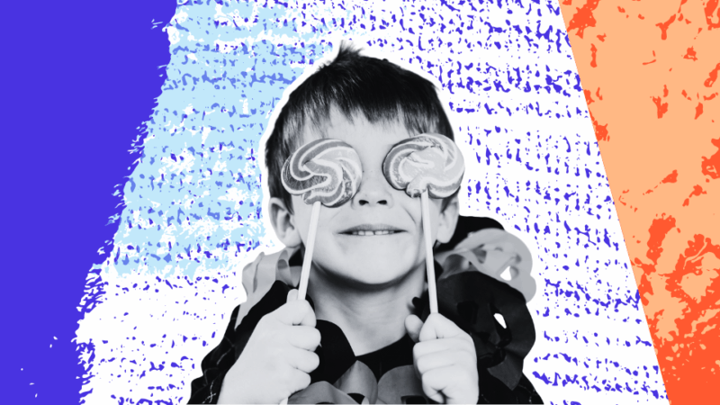 Child in Halloween costume with candy