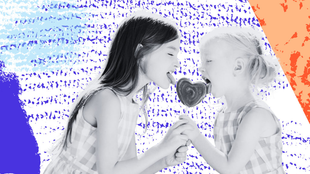 Two kids share a heart-shaped lollipop