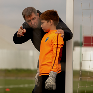 Soccer Coach talking to goalie