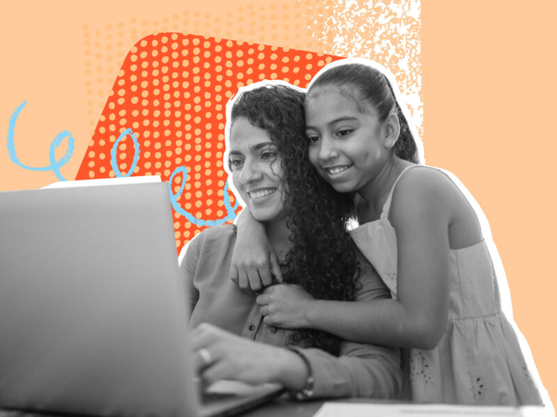 Two people looking at a laptop
