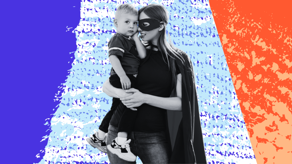 Mom in superhero costume holding child