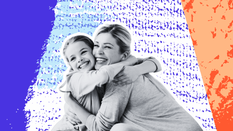 Mother hugging smiling daughter