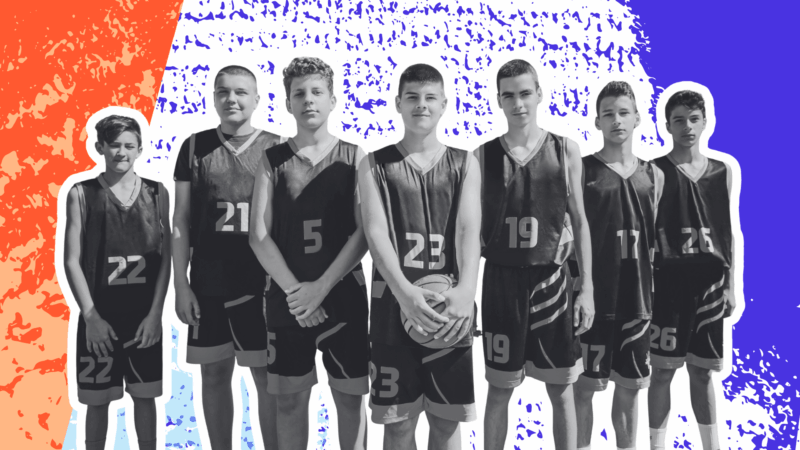 Group of young athletes playing basketball