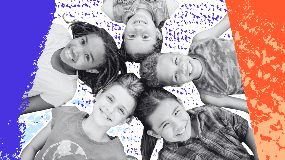 Top-down view of a diverse group of smiling children with heads together, representing community, resilience, and feeling supported.